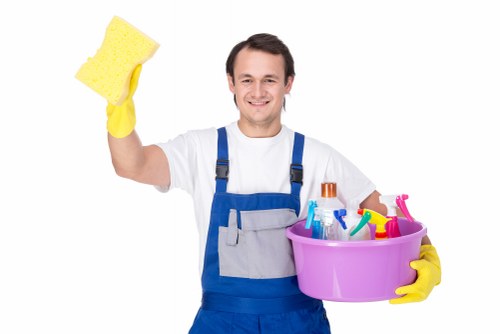 Technician preparing carpet cleaning equipment safely indoors