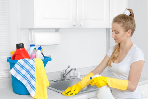 Technician treating stains during commercial carpet cleaning in Nine Elms